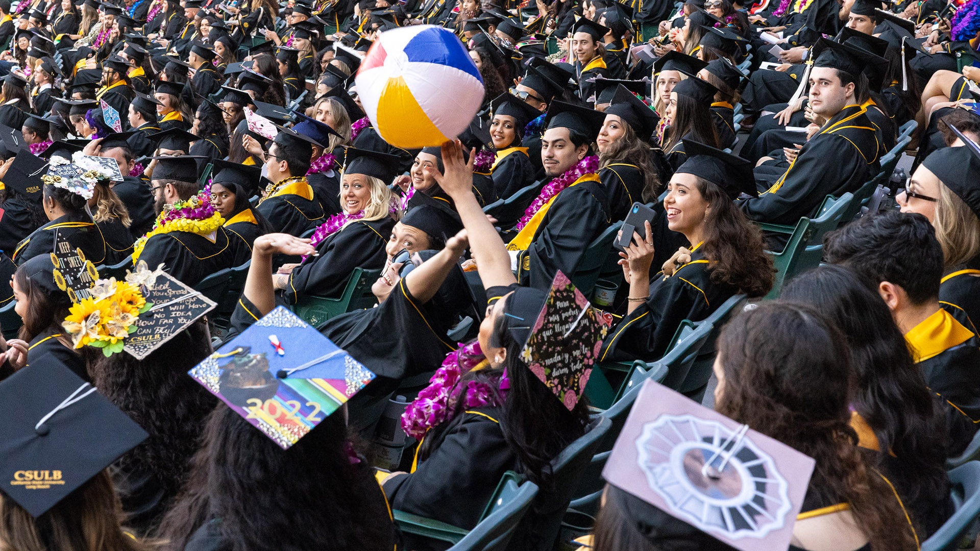 commencement-cla-hero3.jpg Graduates hit a vinyl beach ball through the stands at Comme