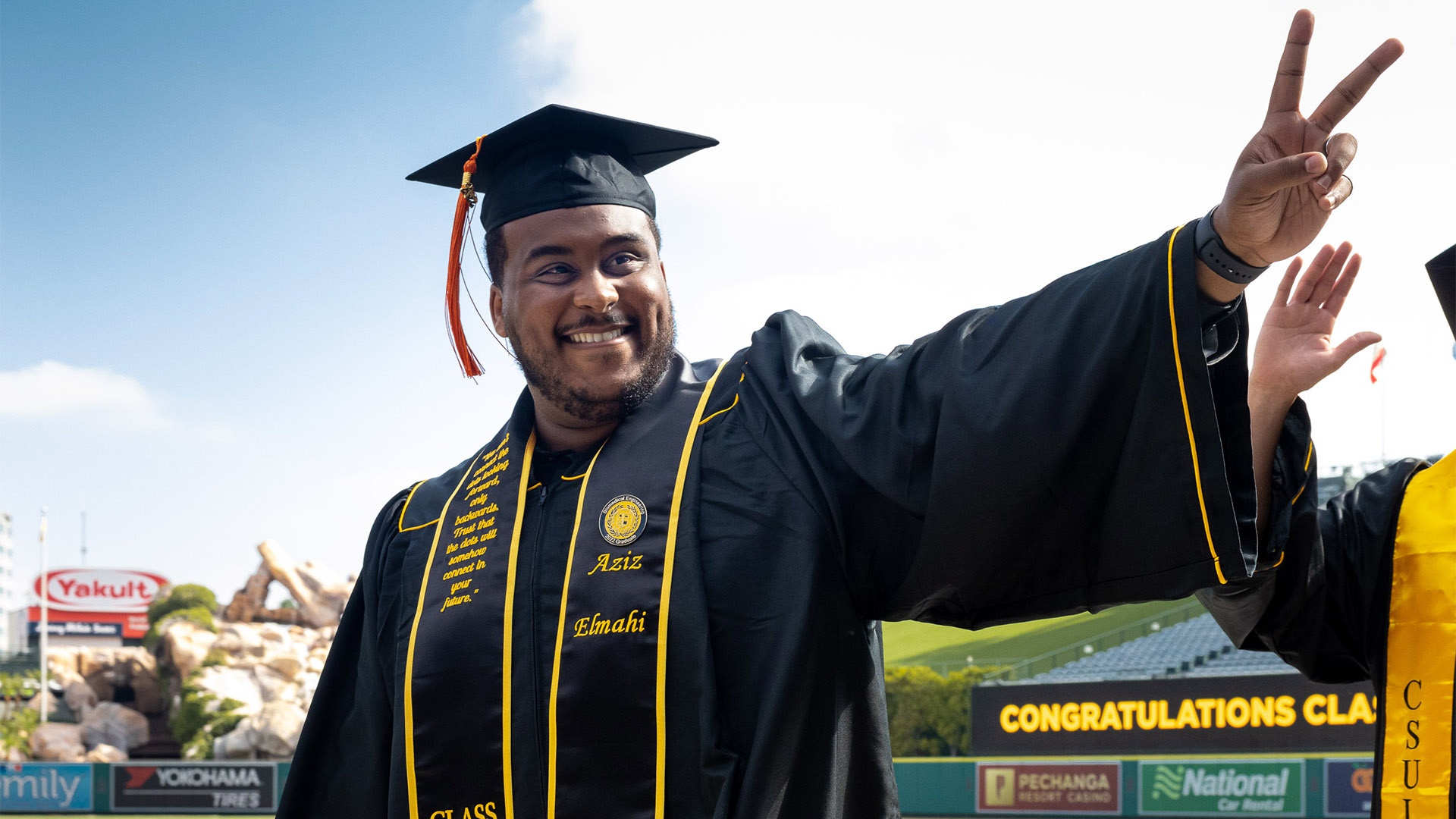 commencement-coe-hero4.jpg A smiling College of Engineering graduate flashes a piece si