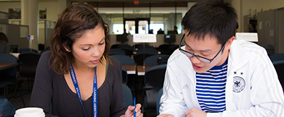 An advisor works with a student