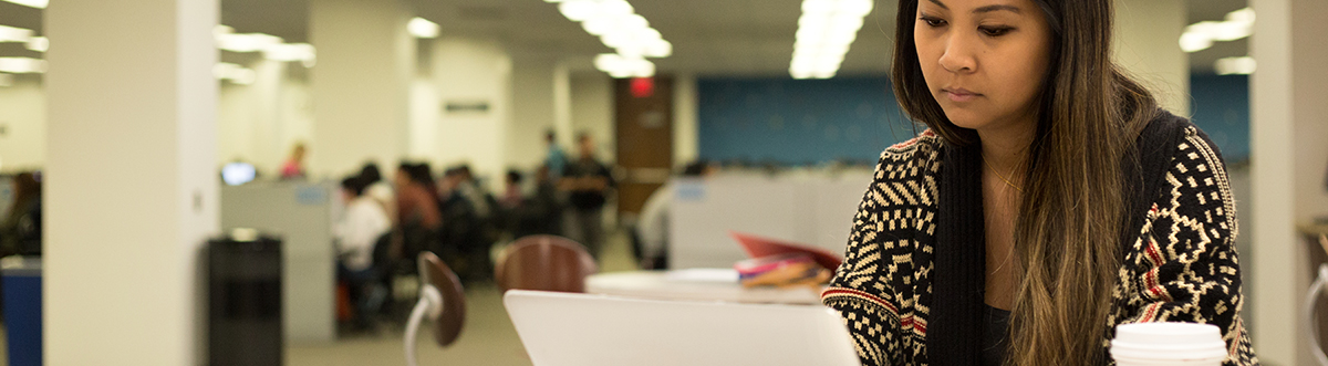 Student in Library on Laptop