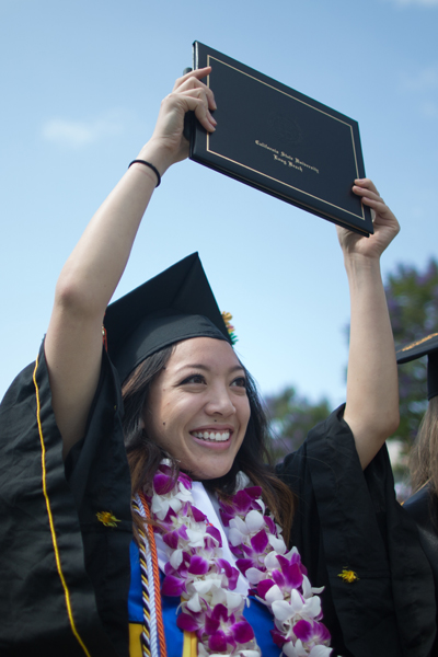 A graduate celebrating at commencement