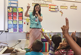 content_ced_big_story_2016-01-26_dang.jpg Ms. Dang teaches kindergartners classroom rules in Vietnames