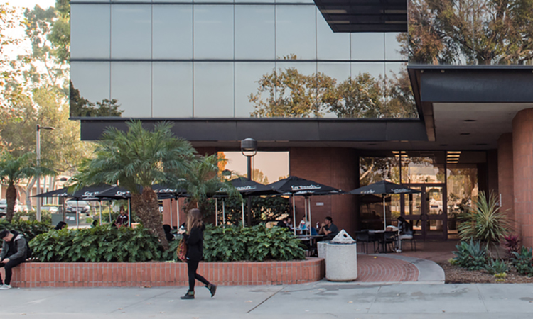 Students walk near the College of Business