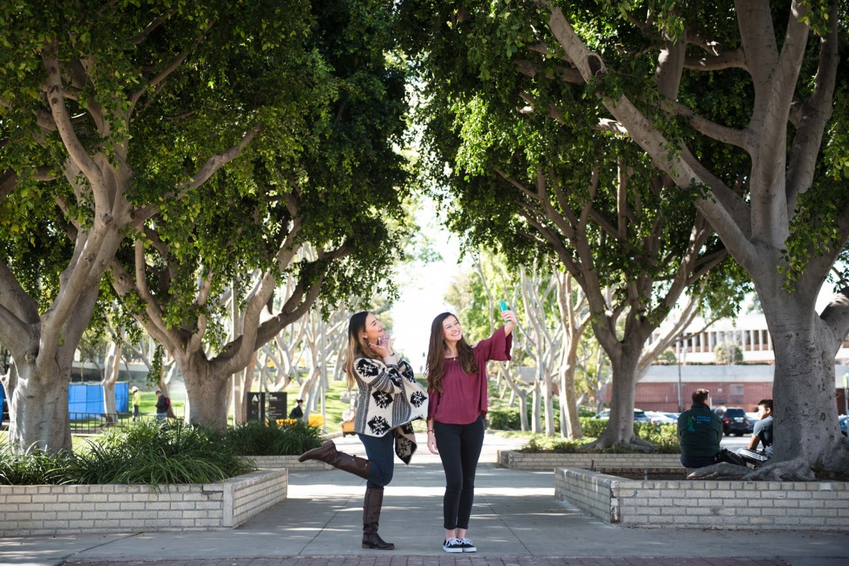 Students at friendship walk taking selfies