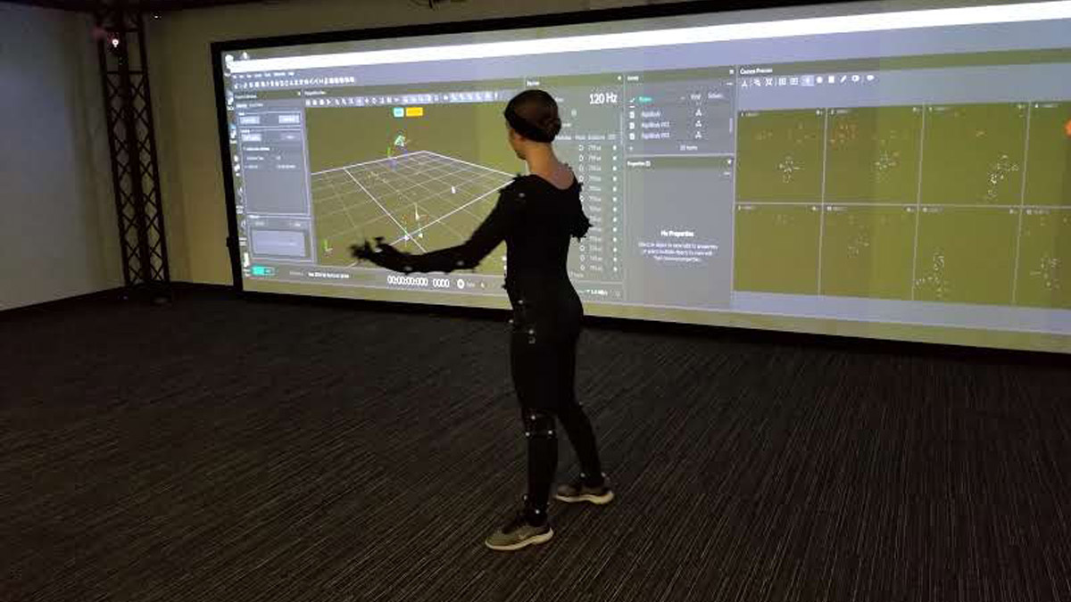 Student plans design on virtual tracking wall