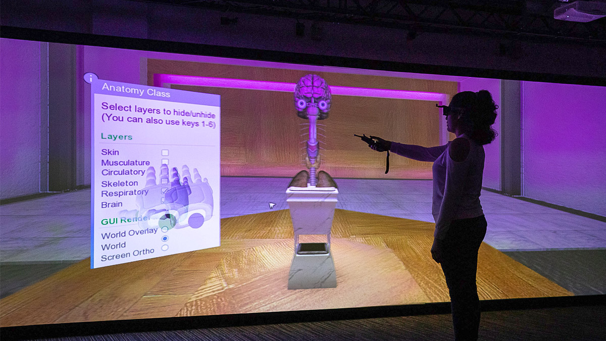 Student holds remote in Virtual Reality Lab