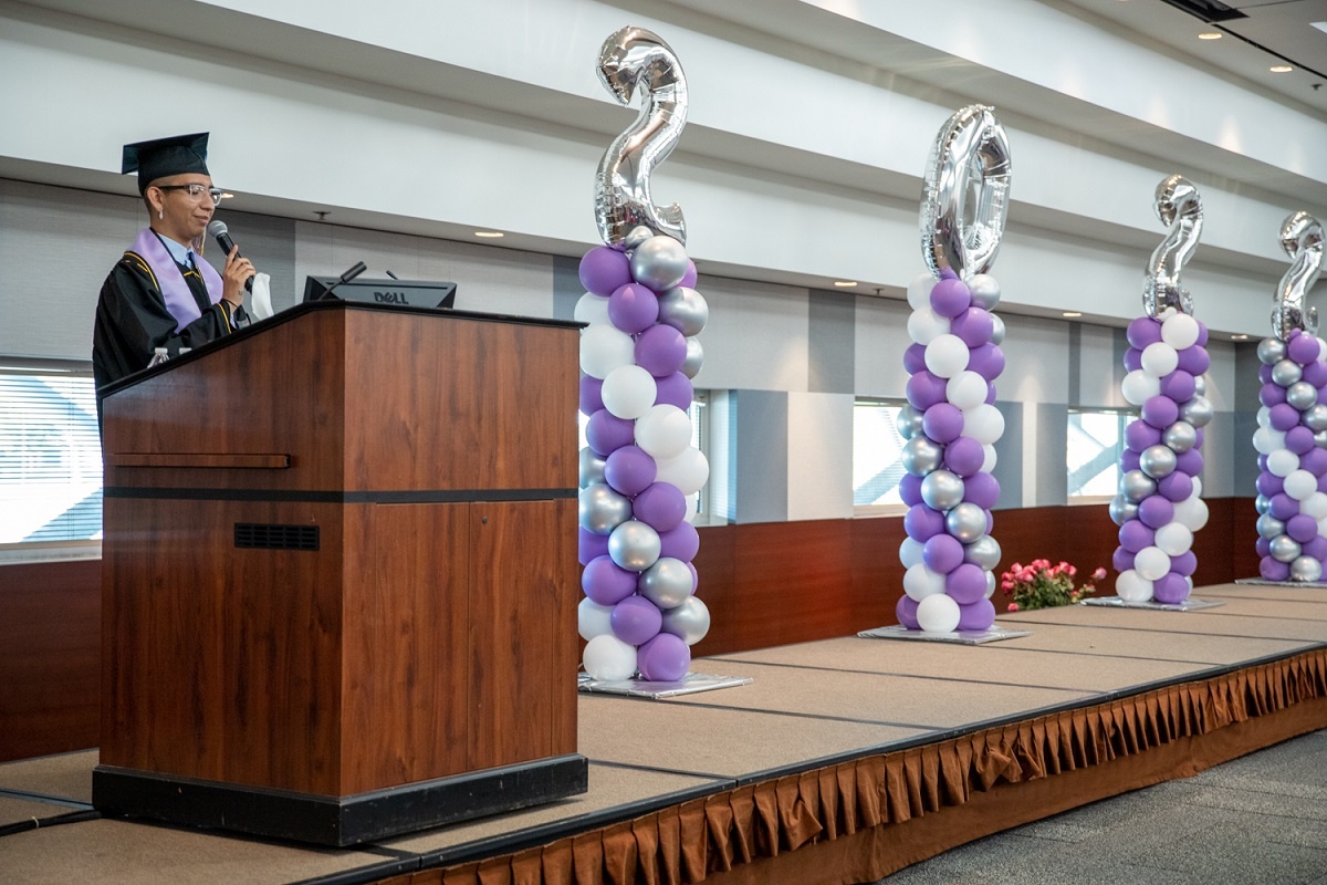 culturalgradutation_lavenderceremony_spring2022-42_rs.jpg A student speaks at the lectern of the 2022 Lavender Cultur