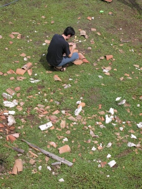 Don playing discarded roof tiles.