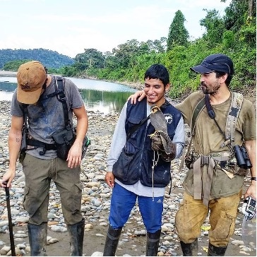 students doing ecology fieldwork with a bird of prey