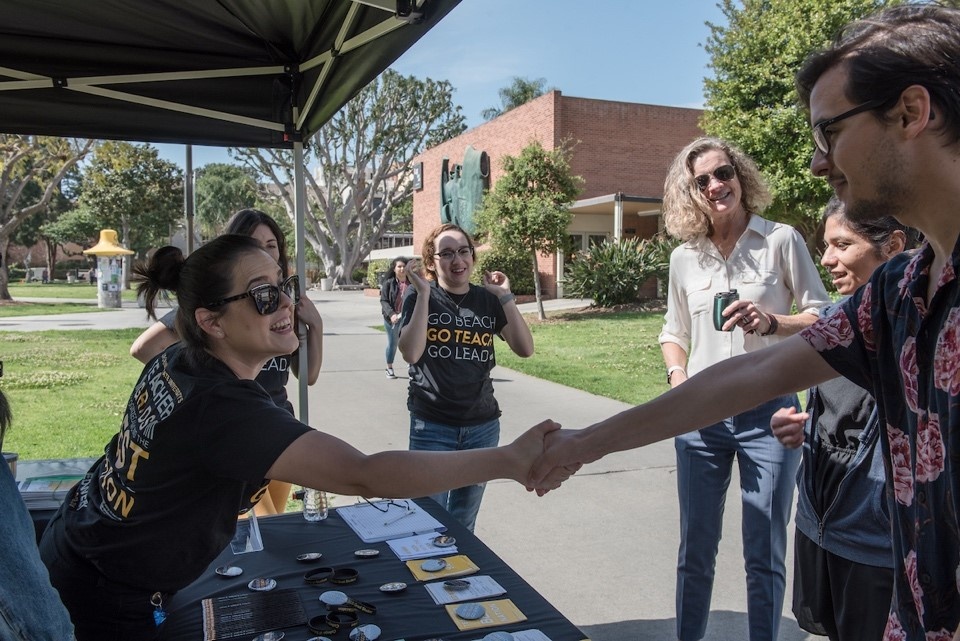 CED staff member Daniela Beltran greeting students on the Qu