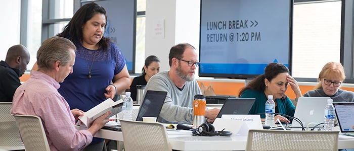 faculty working in classroom at a table together