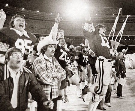 Men's Football team cheer on the sidelines