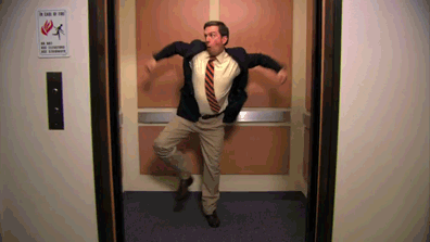 man in suit dancing in elevator
