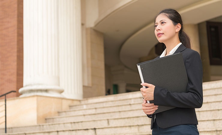 Female government worker standing outside courthouse