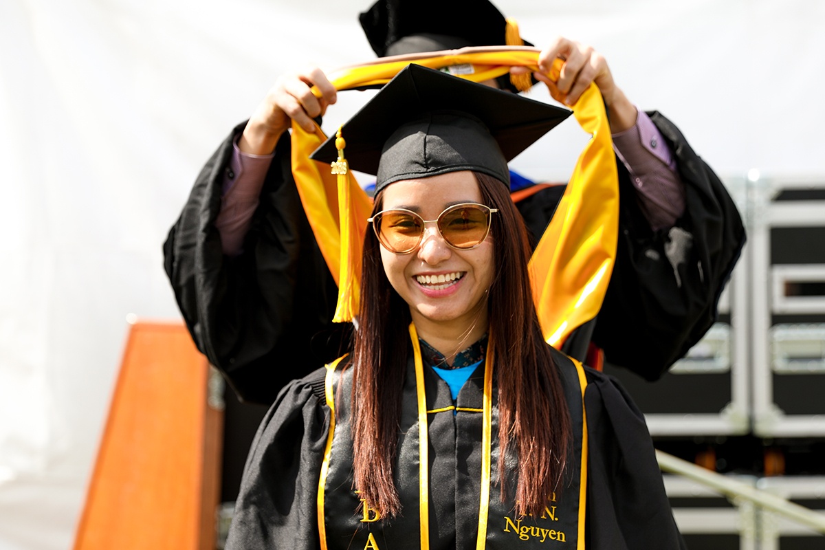 Grad Commencement Student getting hooded