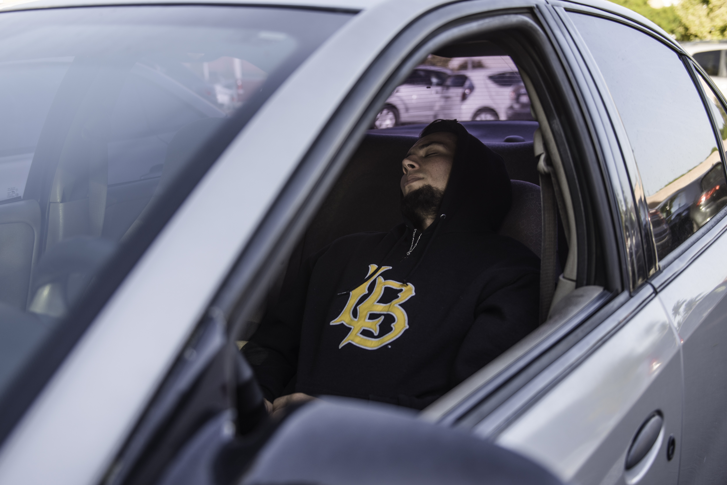 Guy sleeping in car