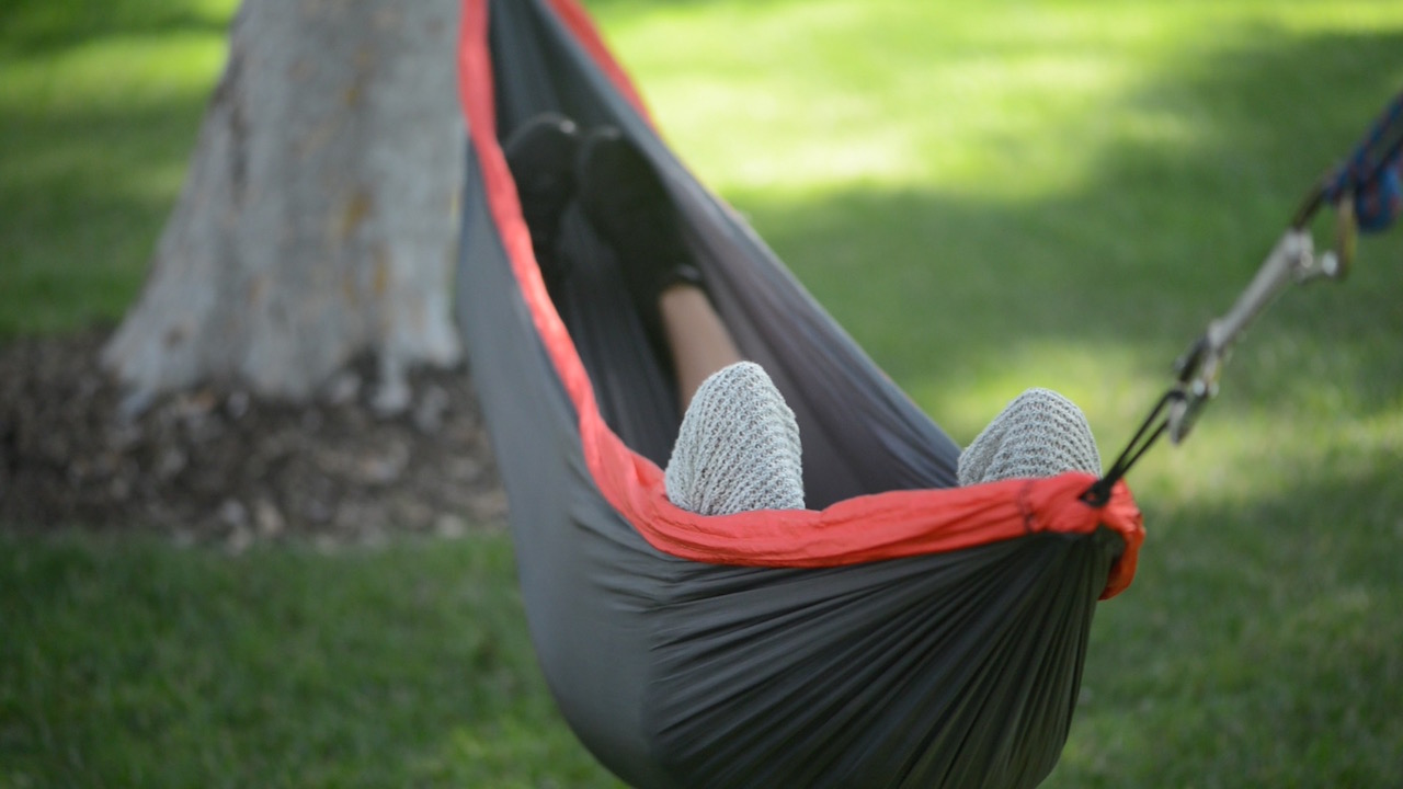 Student relies in a hammock.