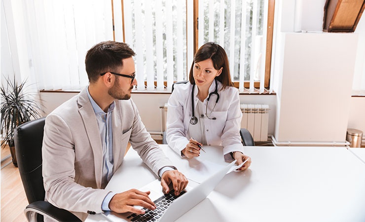 Health care administrator working with doctor