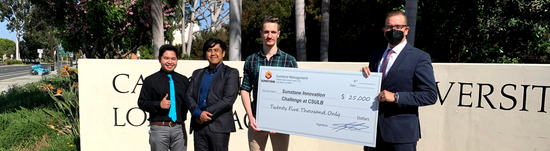 Winners from Vitalink and Unwind receiving a check from Sunstone Management manager for $25,000 