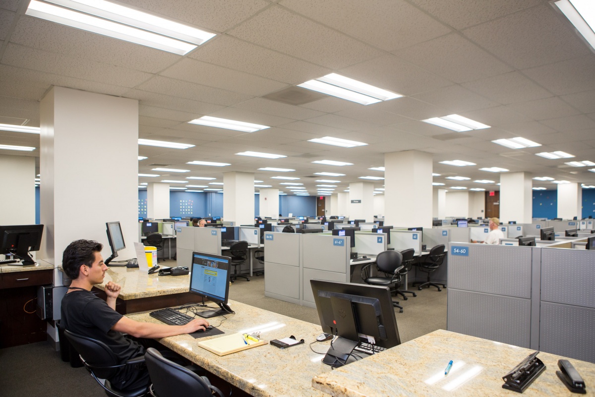 A student worker at his desk in the CSULB library