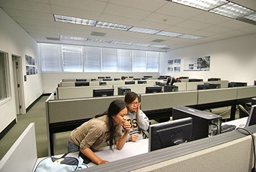 two students collaborating in computer lab