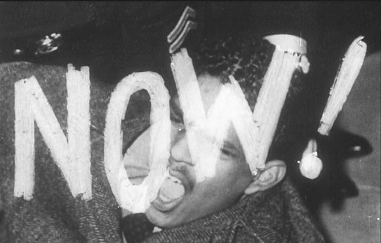 landscape_2.jpg Photo of the word now with a man screaming behind