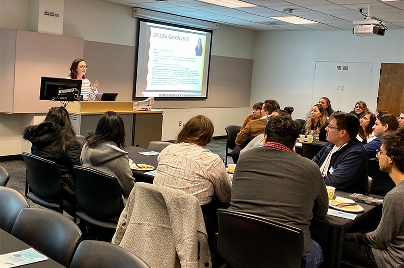 metric_family_mixer_2019_alumni_speech.jpg Diana Gonzalez talking to group