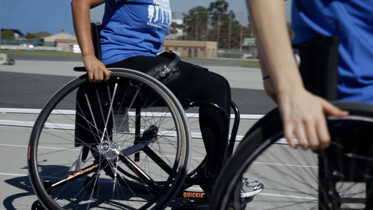 Students and staff try pushing themselves a mile in wheelchairs.