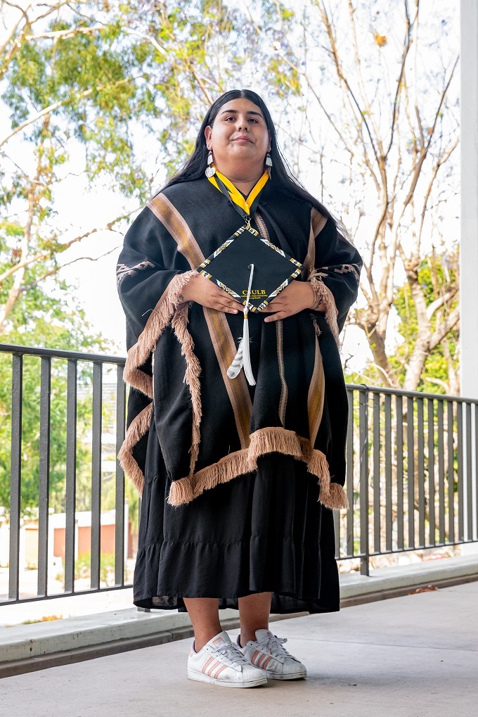 native_american_6_rs.jpg A person in traditional regalia poses at the 2022 Native Ame