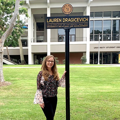 Lauren Dragicevich stands near sigh