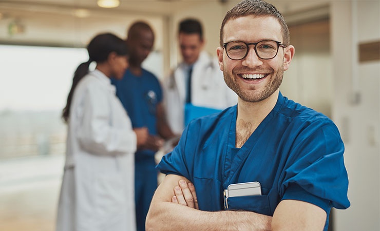 Male nurse standing in front of doctors