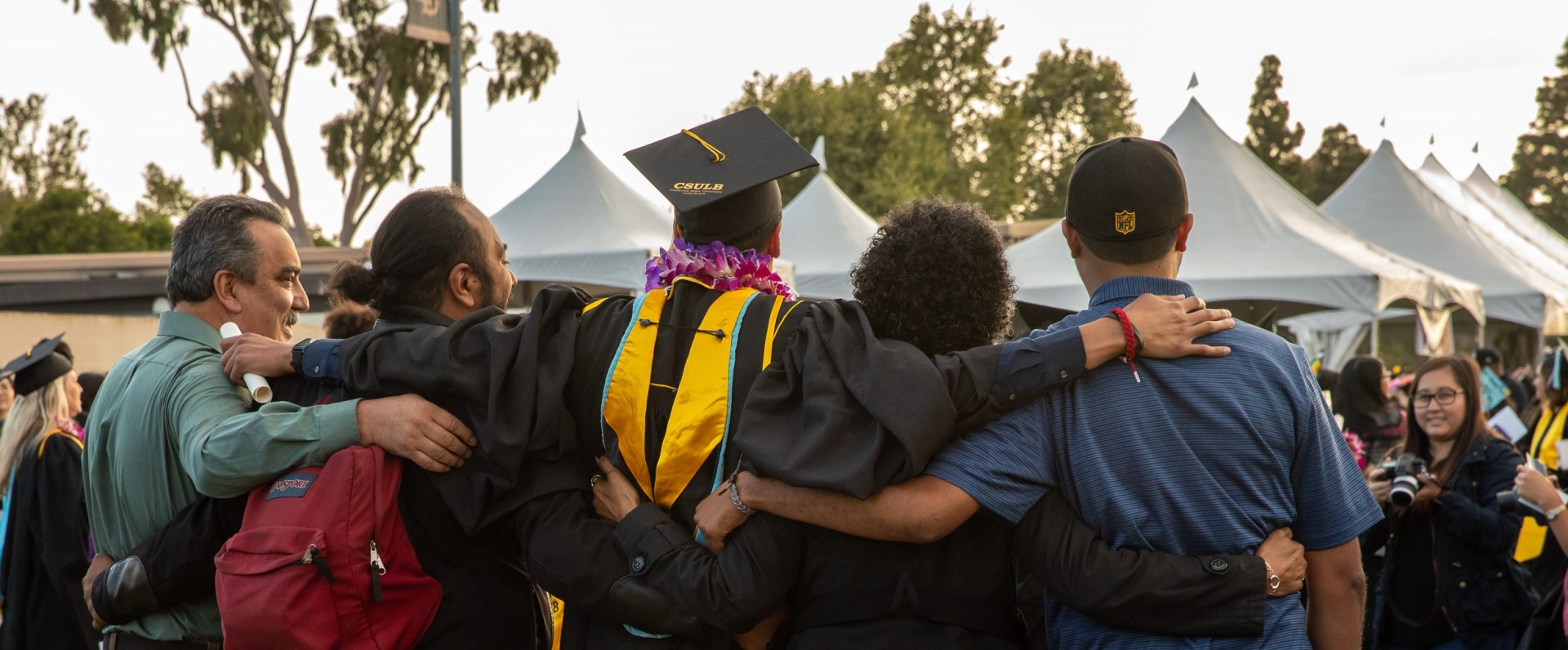 Family hugging student at graduation