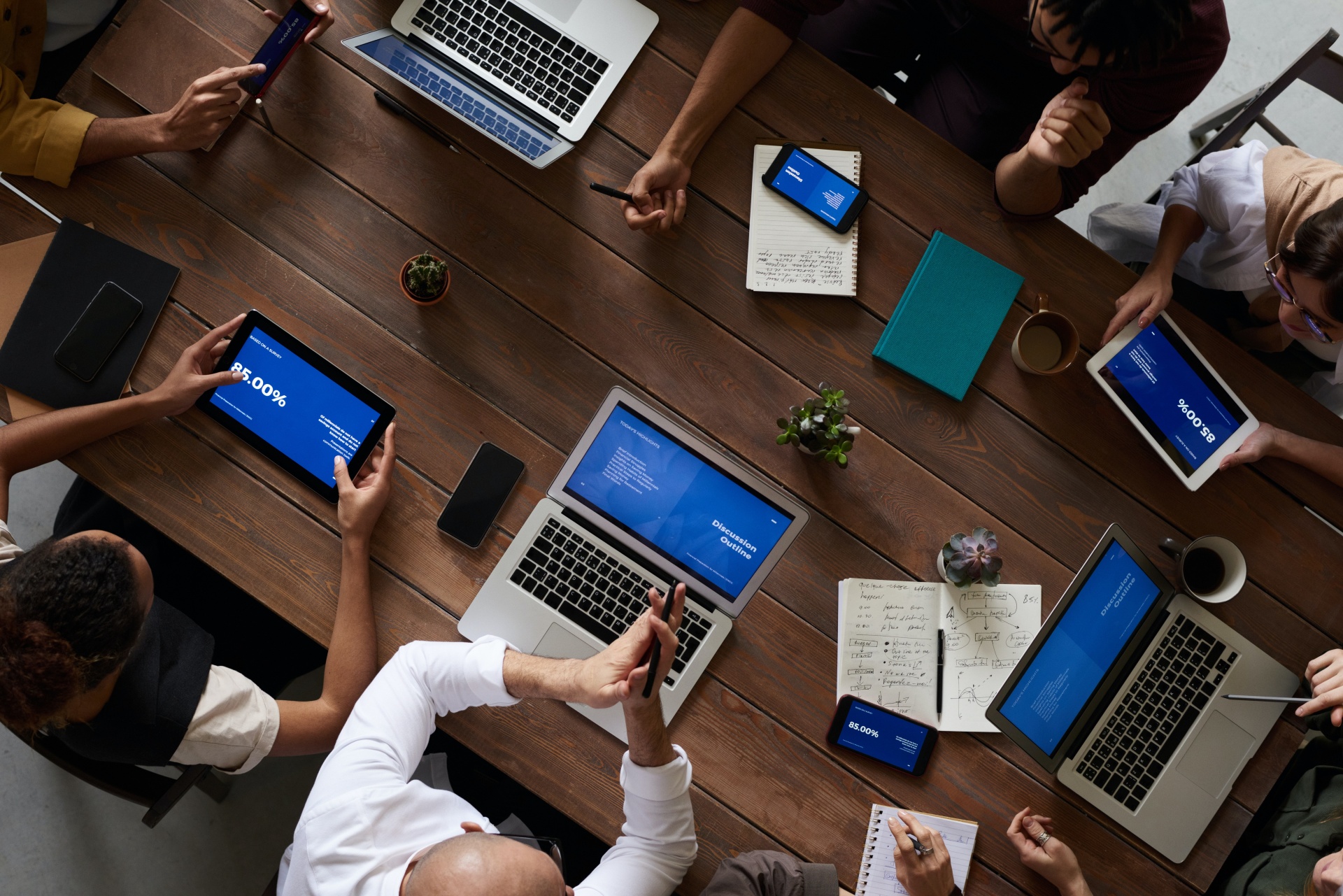 people with computers sitting around a table