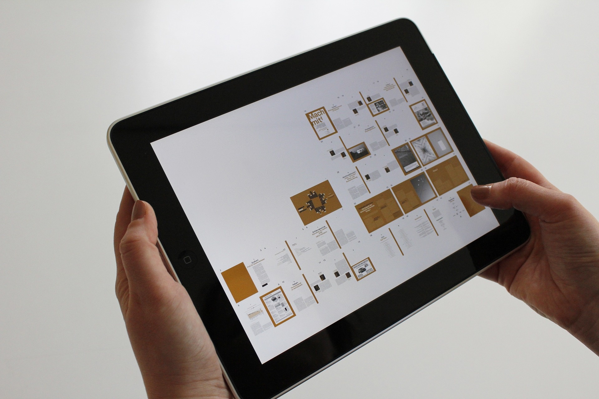 pexels-gd39aca0c4_1920.jpg person holding ipad with pictures of graphs