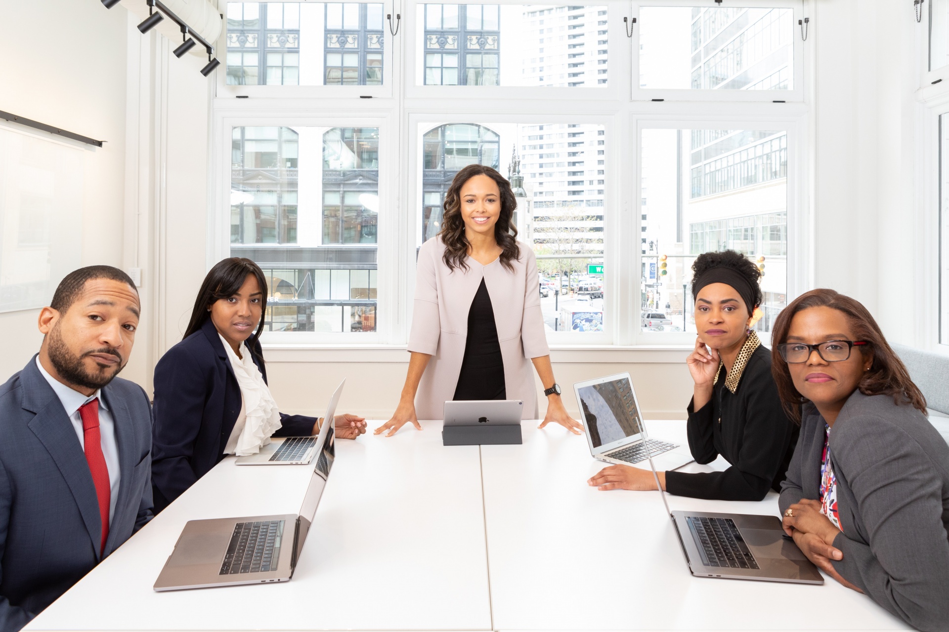 pexels-rebrand-cities-1367271.jpg black women and man in business attire, sitting all around t