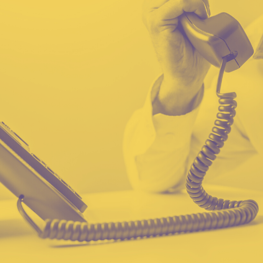phone_mustard_transparency75.png Person holding an office phone