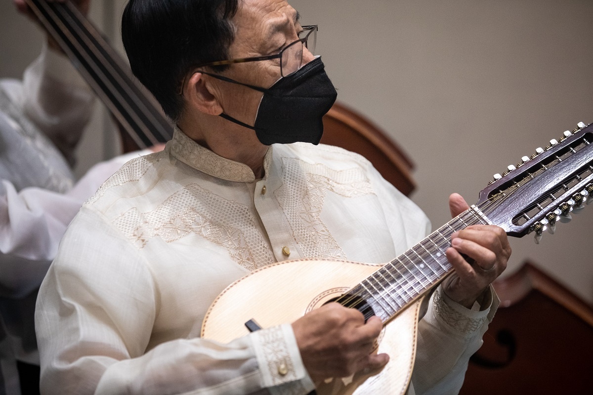 A man plays a stringed instrument at the 2022 Pilipino Cultu