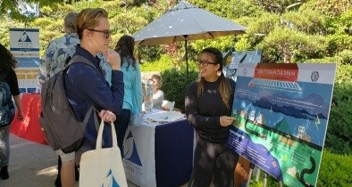 People examining a pollution prevention poster