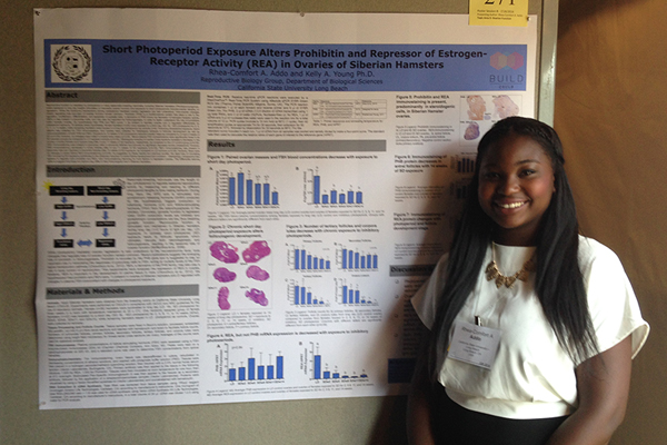 Rhea Addo standing by her poster presentation