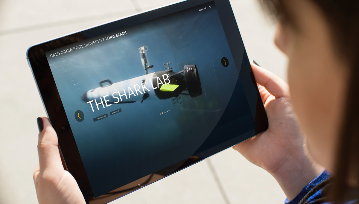 Student holding iPad with Shark Pad displaying
