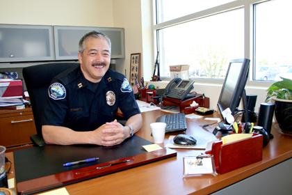 Director Ron Mark sitting at his desk