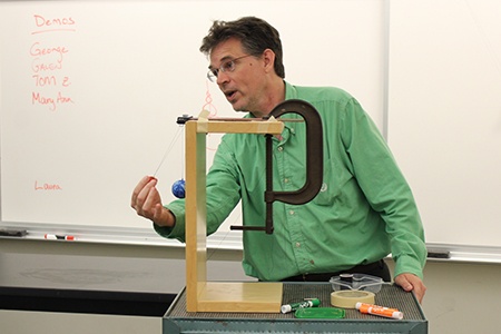 teacher doing a demonstration with force and motion