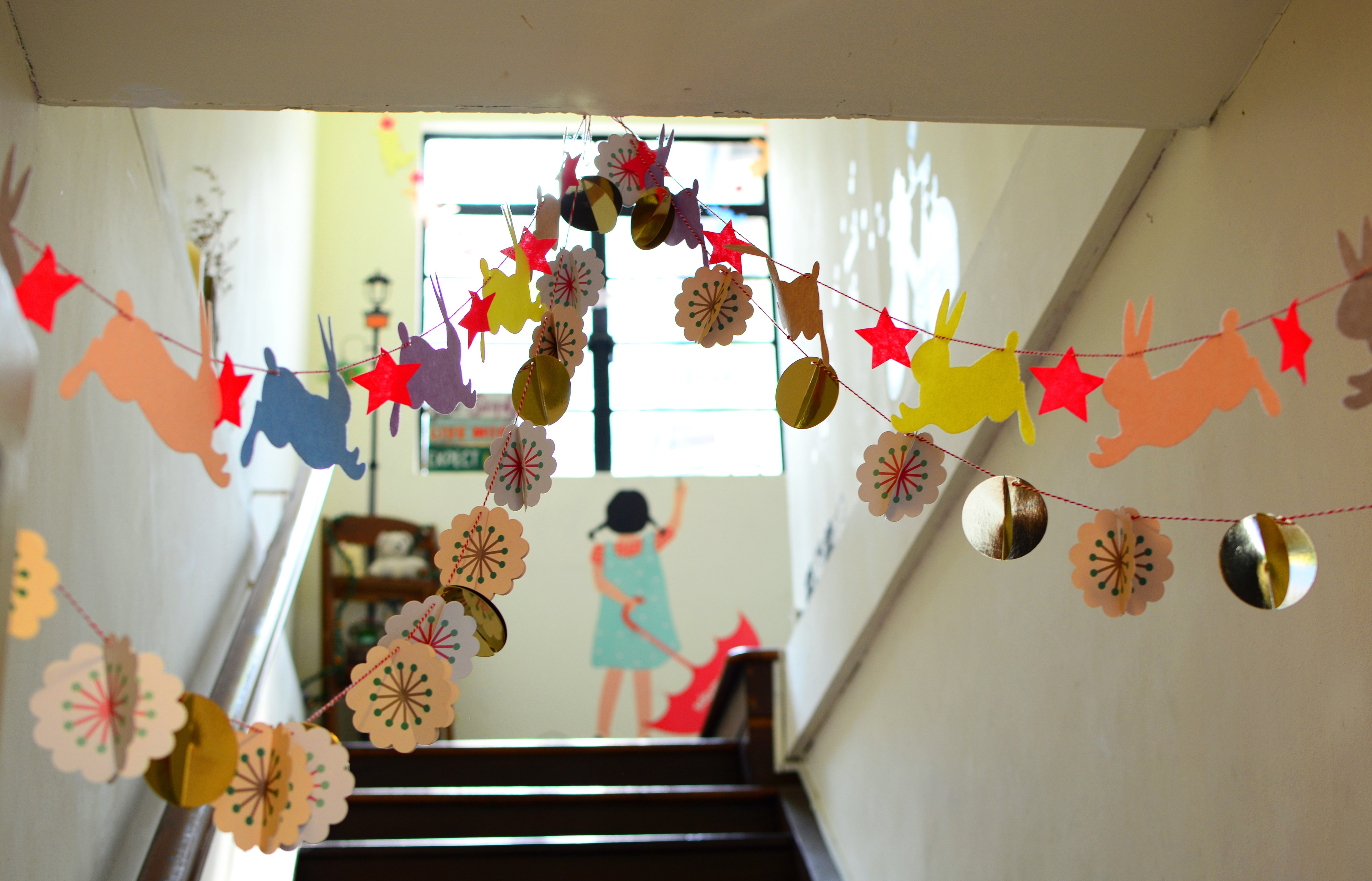 Picture of a school hallway with brightly colored paper garlands hanging from the ceiling