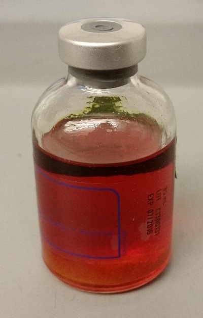 glass vial of orange skunk oil