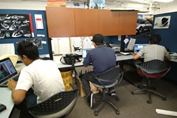 three students working in the studio