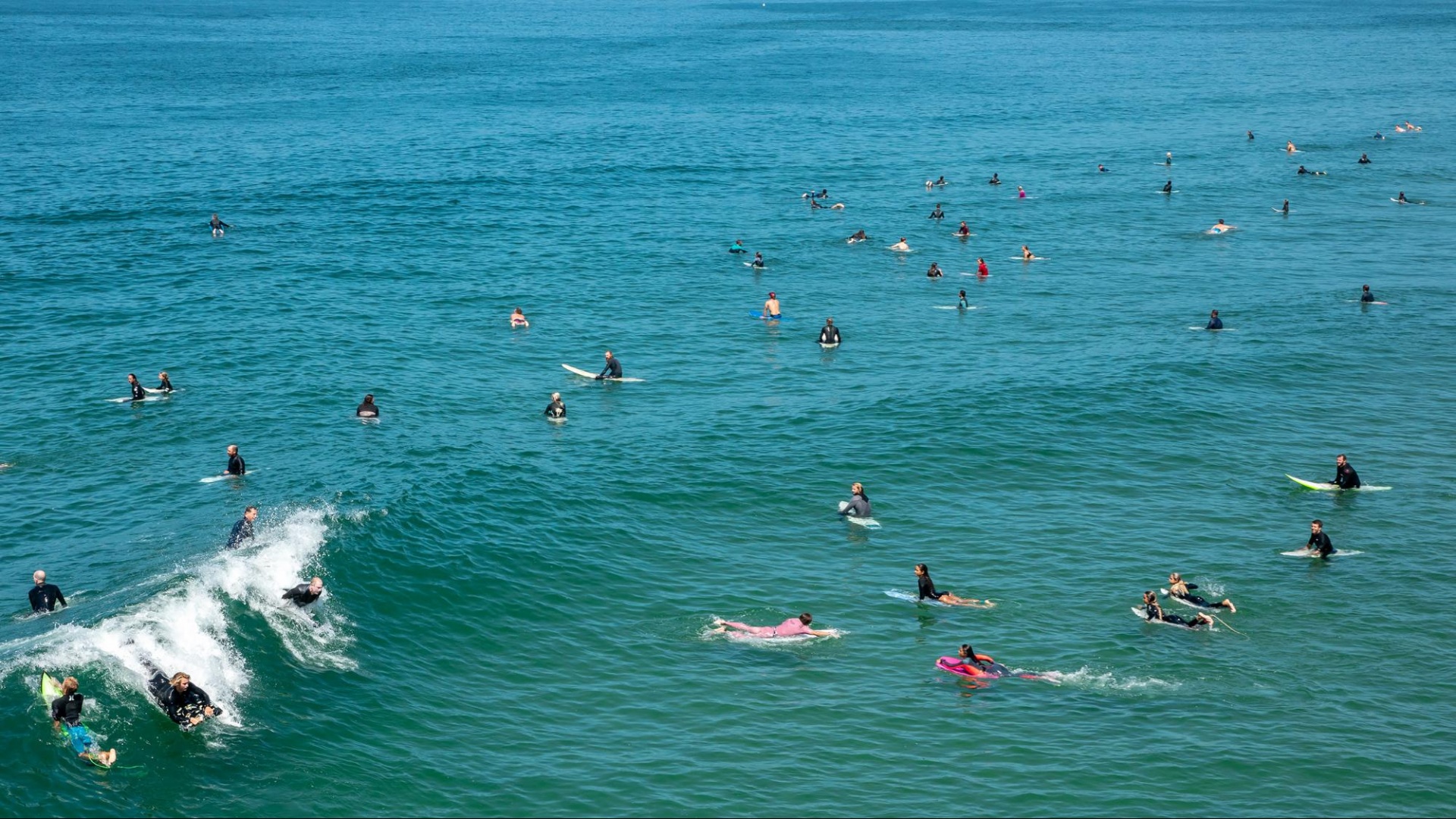 surfers looking at incoming wave