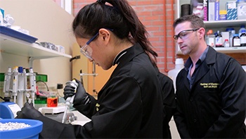 a trainee working with her mentor in the lab
