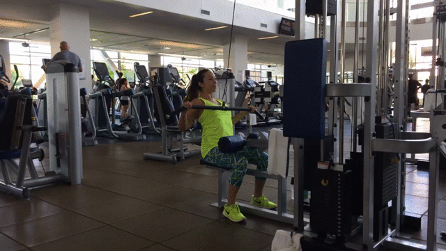 female student working out on weight machines at student rec