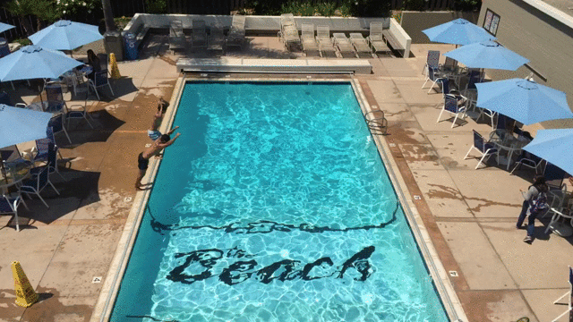 trim.bbe33c6e-ca6f-4c9d-a5bc-07571dd35f45.gif two people somersaulting into pool