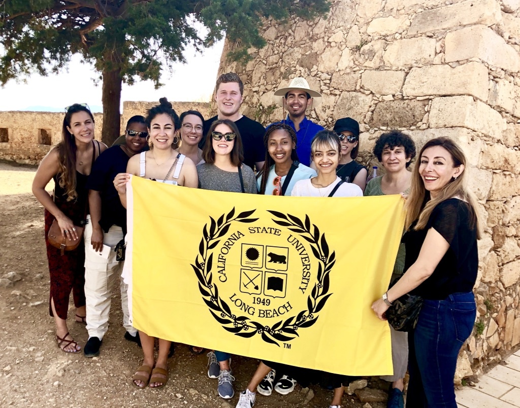 Group of Students and Dr. Ghafoori holding a CSULB Banner in